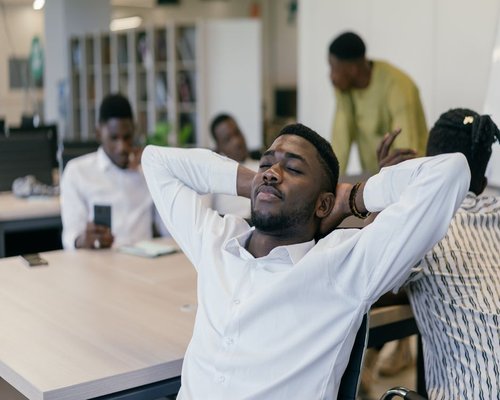 A man taking a relaxed break during office work